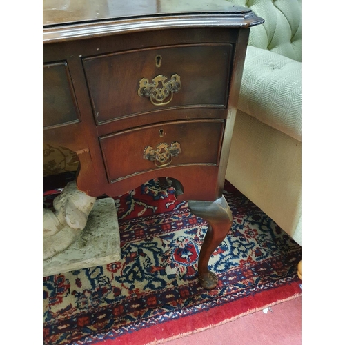 144 - A late 19th early 20th Century Serpentine fronted Mahogany Desk with cabriole supports. 106 x 50 x 7... 