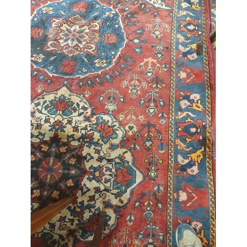 235 - A red ground Persian Carpet. 320 x 188 cms approx.