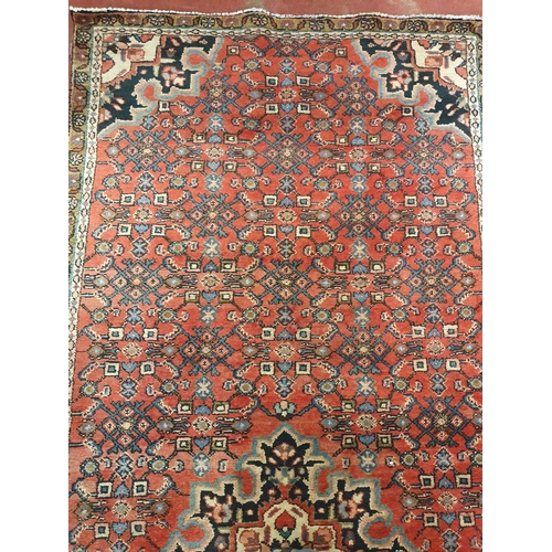 326 - A Persian red ground Carpet.295x120 cms approx.