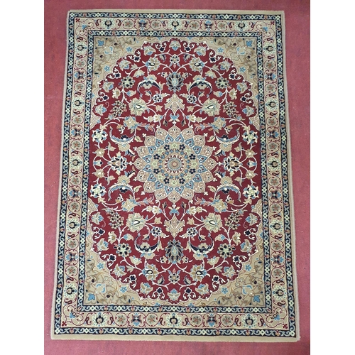 63 - A beige ground Persian Rug with all over design. 145 x 100cms approx.