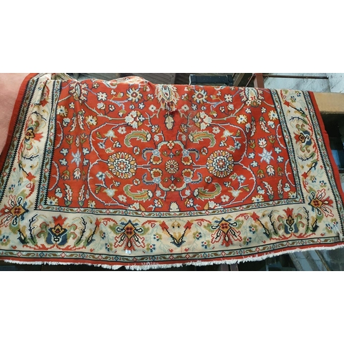 215 - A large Rug. approx 280 x 250 cms. (As found). A large Pink ground Rug. Approx 340 x 240 cms.