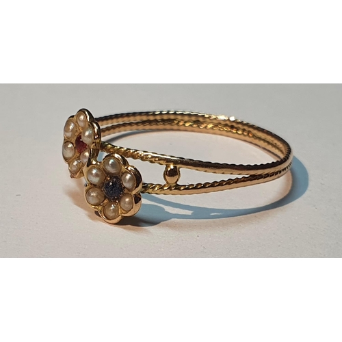 303 - A split pearl and gem-set floral dress ring.
Ring size P. 1.2gms.