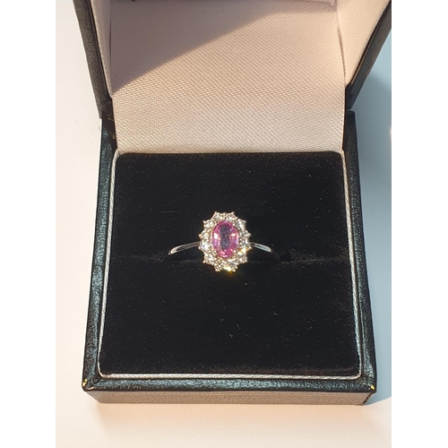 304 - An 18ct gold pink sapphire and diamond cluster ring. Pink sapphire weight 0.53ct. Total diamond weig... 