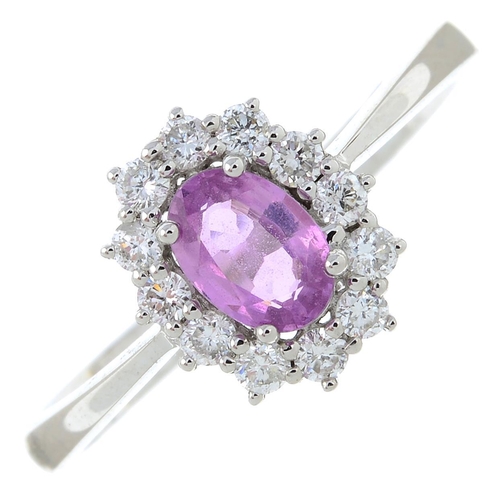 304 - An 18ct gold pink sapphire and diamond cluster ring. Pink sapphire weight 0.53ct. Total diamond weig... 