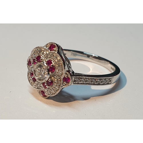 311 - An 18ct gold diamond and ruby cluster ring. Total ruby weight 0.16ct.Total diamond weight 0.39ct.Hal... 
