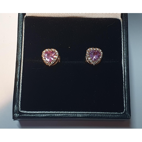 314 - A pair of pink sapphire and diamond heart-shape earrings. Total sapphire weight 0.78ct, stamped to m... 