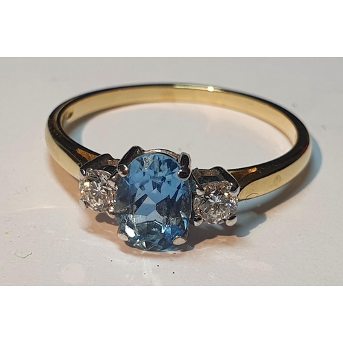 315 - An 18ct gold topaz and brilliant-cut diamond three-stone ring.