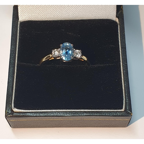 315 - An 18ct gold topaz and brilliant-cut diamond three-stone ring.