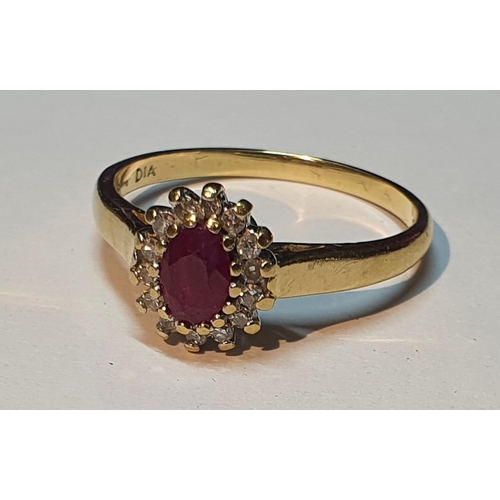 318 - An 18ct gold ruby and diamond cluster ring. Estimated total diamond weight 0.15ct. Hallmarks for 18c... 