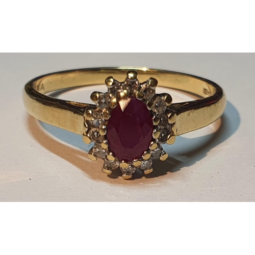 318 - An 18ct gold ruby and diamond cluster ring. Estimated total diamond weight 0.15ct. Hallmarks for 18c... 