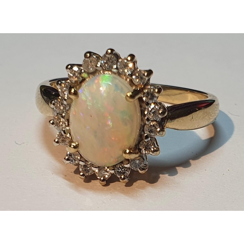 319 - A 9ct gold opal and brilliant-cut diamond cluster ring. Estimated total diamond weight 0.20ct. Hallm... 