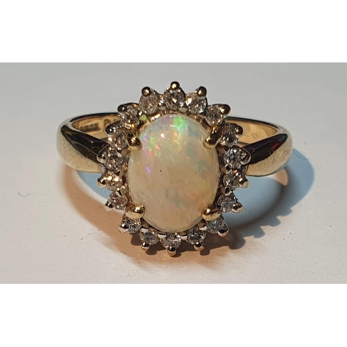 319 - A 9ct gold opal and brilliant-cut diamond cluster ring. Estimated total diamond weight 0.20ct. Hallm... 