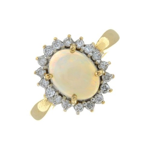 319 - A 9ct gold opal and brilliant-cut diamond cluster ring. Estimated total diamond weight 0.20ct. Hallm... 