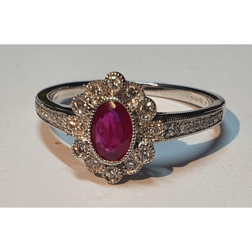 321 - An 18ct gold ruby and diamond cluster ring. Ruby weight 0.41ct. Total diamond weight 0.16ct. Hallmar... 