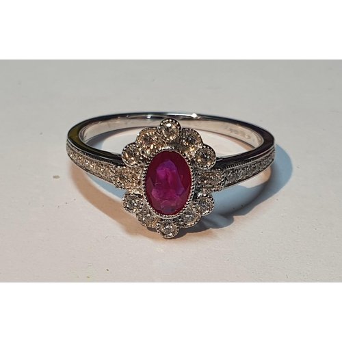 321 - An 18ct gold ruby and diamond cluster ring. Ruby weight 0.41ct. Total diamond weight 0.16ct. Hallmar... 