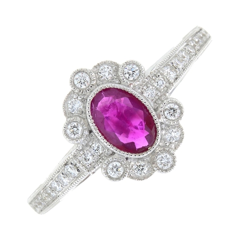 321 - An 18ct gold ruby and diamond cluster ring. Ruby weight 0.41ct. Total diamond weight 0.16ct. Hallmar... 