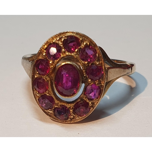 325 - Ruby cluster ring, stamped 9ct, ring size L1/2, 3.3gms.