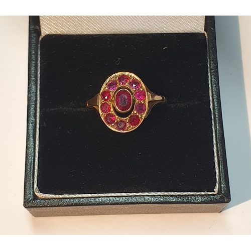 325 - Ruby cluster ring, stamped 9ct, ring size L1/2, 3.3gms.