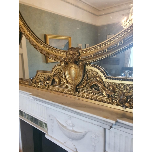 136 - A Most Magnificent 19th Century Timber and Plaster Gilt Overmantel Mirror. The oval centre supported... 