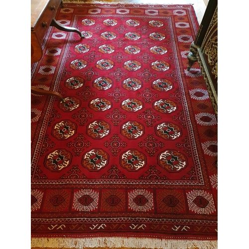 68 - A Rich red ground full pile hand woven Turkmen double knot Carpet in traditional Bokhara allover des... 