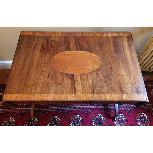 69 - A Regency Mahogany Sofa Table with an oval crossbanded top on twin splayed supports and with brass c... 