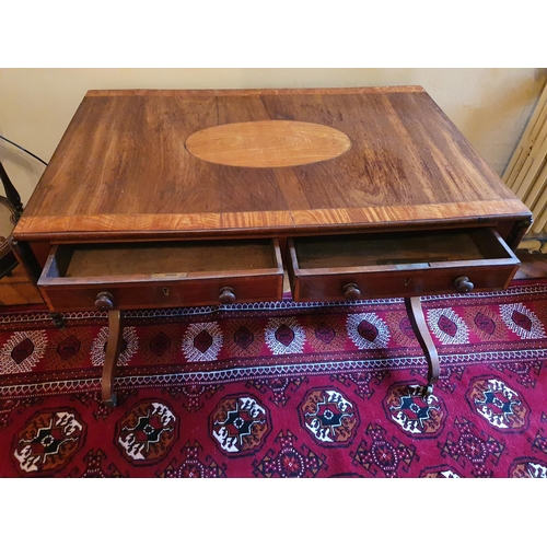 69 - A Regency Mahogany Sofa Table with an oval crossbanded top on twin splayed supports and with brass c... 