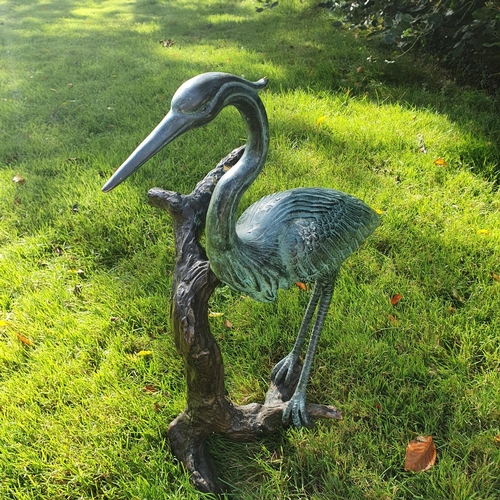 763 - A fabulous Bronze Crane standing on a branch.