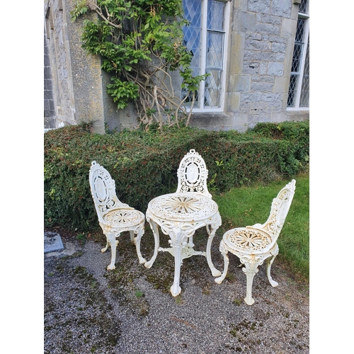 759 - A fabulous heavy cast iron set of three Chairs and Table with pierced outline.