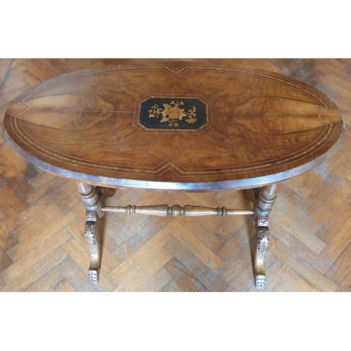 752 - A Victorian Walnut and veneered oval Center Table on stretcher base.