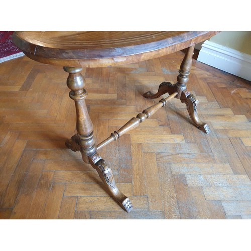 752 - A Victorian Walnut and veneered oval Center Table on stretcher base.