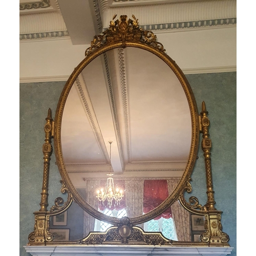 136 - A Most Magnificent 19th Century Timber and Plaster Gilt Overmantel Mirror. The oval centre supported... 