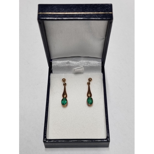 23a - A apir of Gold and Emerald drop Earrings.