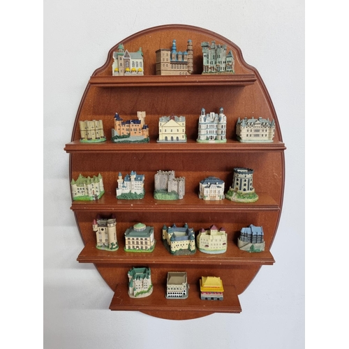 154 - A quantity of Buildings on a wall mounted shelves.