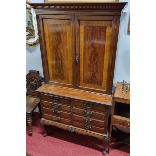 92 - A good early 20th Century Mahogany Cupboard with shelved interior top and a bank of eight drawers an... 