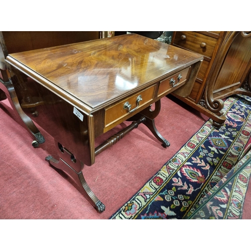 737 - A good Mahogany and veneered Sofa Table with twin drawer frieze splayed legs and brass castors.