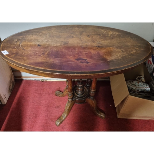 71 - A 19th Century oval Walnut Supper Table with inlaid top and pod base. (slight repair required on top... 