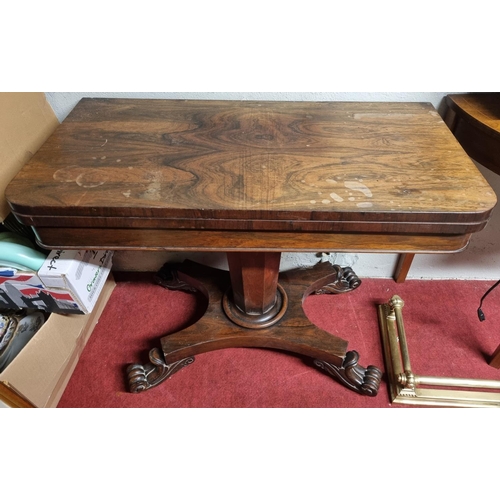 85 - An early 19th Century Rosewood foldover Card Table with platform base and carved toes on octagonal s... 