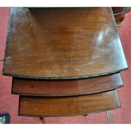 98 - A really good Mahogany Nest of three Tables with carved edge outline on turned supports and stretche... 