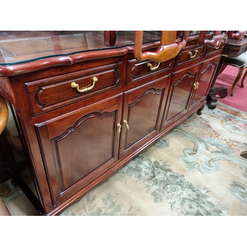 615 - A Hardwood four door Sideboard with four drawer frieze with glass top. 182 x 48 x H 87 cm approx.