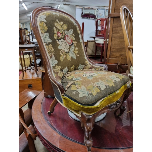 648 - A good 19th Century Mahogany showframe Armchair with tapestry style upholstered seat and back on car... 
