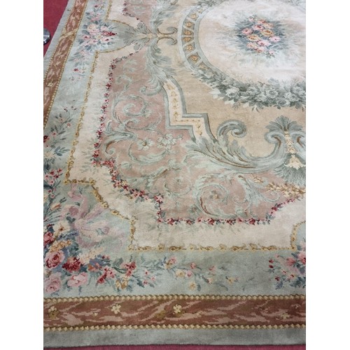 650 - A Large Aubusson style cream and green ground Carpet with central floral motif surrounded by floral ... 