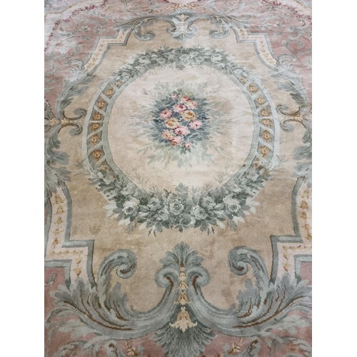 650 - A Large Aubusson style cream and green ground Carpet with central floral motif surrounded by floral ... 