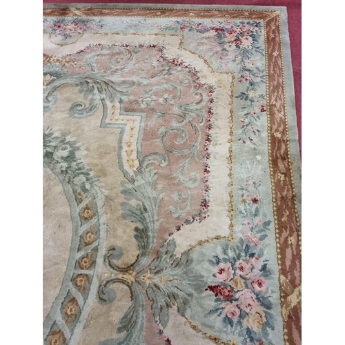 650 - A Large Aubusson style cream and green ground Carpet with central floral motif surrounded by floral ... 