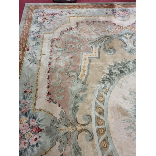 650 - A Large Aubusson style cream and green ground Carpet with central floral motif surrounded by floral ... 