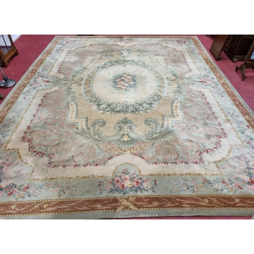 650 - A Large Aubusson style cream and green ground Carpet with central floral motif surrounded by floral ... 