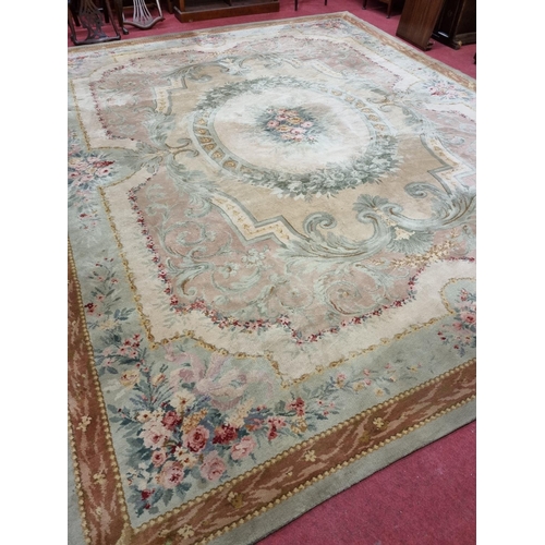 650 - A Large Aubusson style cream and green ground Carpet with central floral motif surrounded by floral ... 
