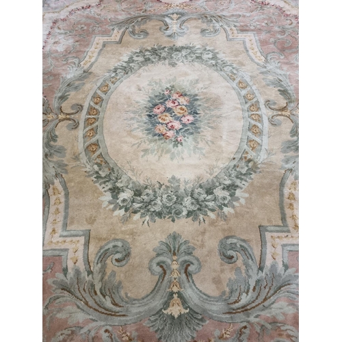 650 - A Large Aubusson style cream and green ground Carpet with central floral motif surrounded by floral ... 