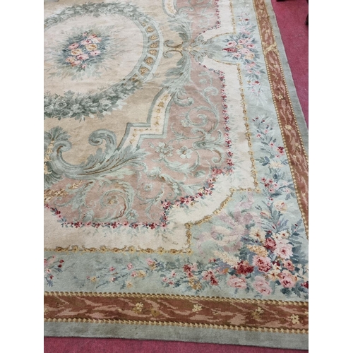 650 - A Large Aubusson style cream and green ground Carpet with central floral motif surrounded by floral ... 