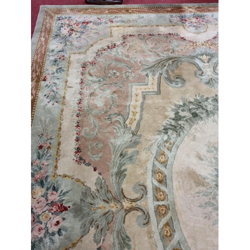 650 - A Large Aubusson style cream and green ground Carpet with central floral motif surrounded by floral ... 