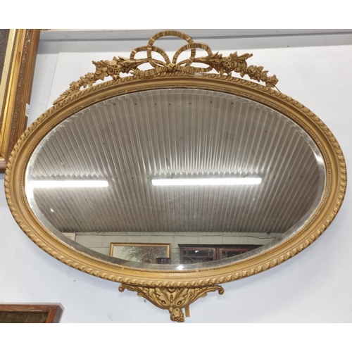 669 - A 19th Century oval Gilt Mirror with cartouche top. 82 x 72 cm approx.